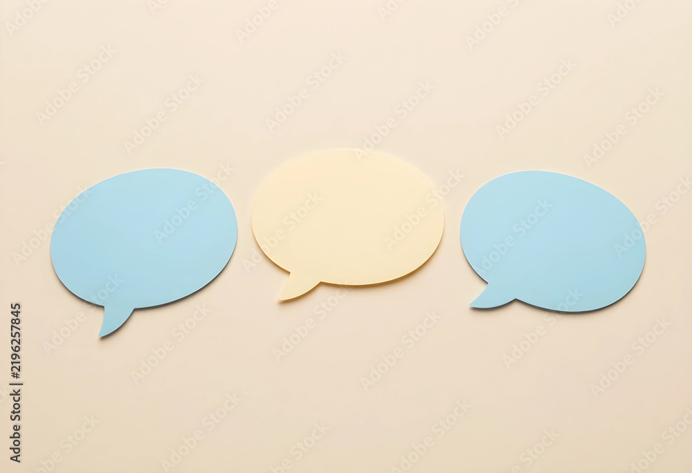 Obraz premium Communication and feedback concept, blank speech bubbles for social media messaging and customer service dialogue on a neutral beige background