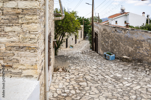 Quiet narrow cobbled street lined with old stone houses in center of mountain village Lefkara in Cyprus