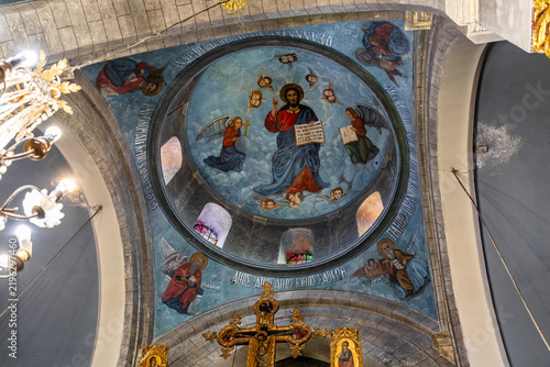 Main dome adorned with religious paintings in main hall in Church of the Holy Cross in mountain village Lefkara in Cyprus