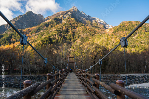 Beautiful autumn landscape of Myojin Bridge and the Azusa River in Kamikochi, Matsumoto, Nagano Prefecture, Japan.