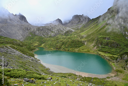 Turquoise Water of Abujicuo Lake Surrounded by Steep Mountain Peaks in Shangri-La, China