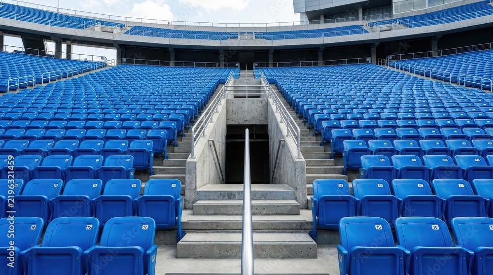Fototapeta premium Empty Blue Seats in a Large Modern Sports Stadium Arena with Concrete Stairs and Central Entrance Tunnel