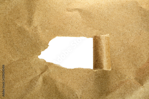 Torn kraft paper texture with curled edge revealing transparent background