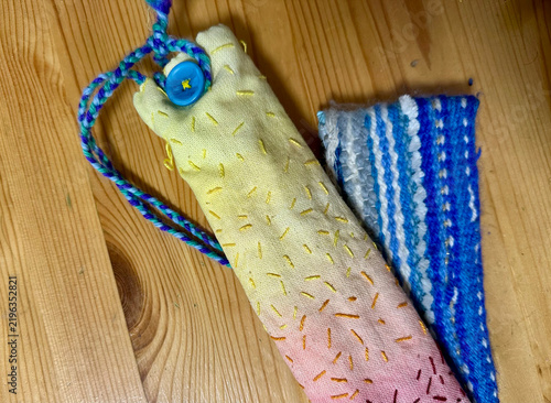 Handmade Waldorf Inspired Embroidered Pencil Case Pouch with Strap on Wooden Background

