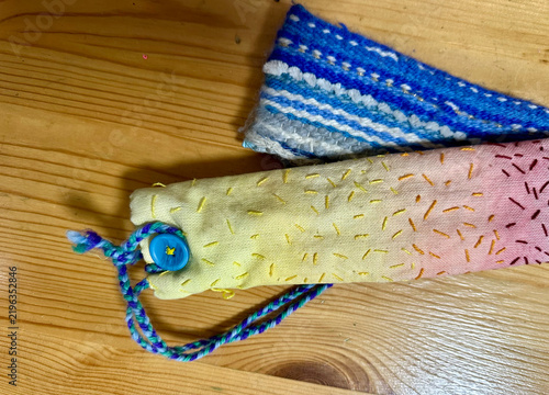 Handmade Waldorf Inspired Embroidered Pencil Case Pouch with Strap on Wooden Background

