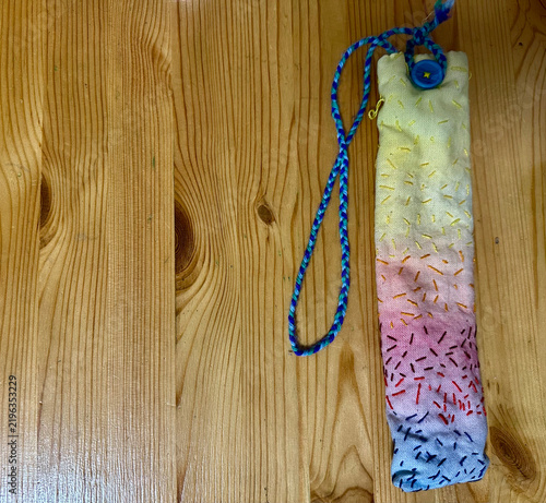 Handmade Waldorf Inspired Embroidered Pencil Case Pouch with Strap on Wooden Background

