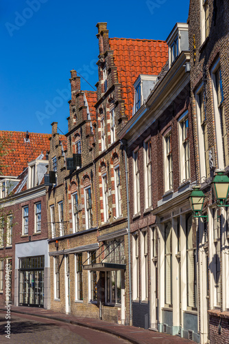 Row of historic Dutch houses along a curved street in the historic town center of Oudewater, Utrecht, Netherlands.