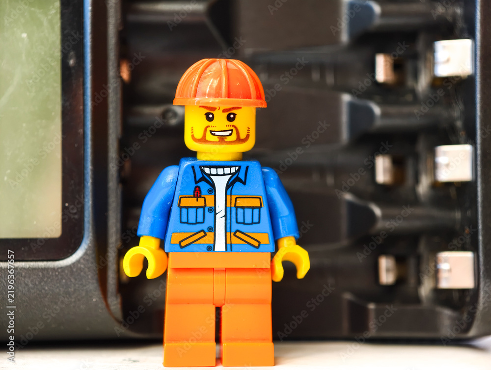 Fototapeta premium Russia, St. Petersburg, August 8, 2020 A close-up of a Lego man wearing a hard hat, perfect for illustrations and designs