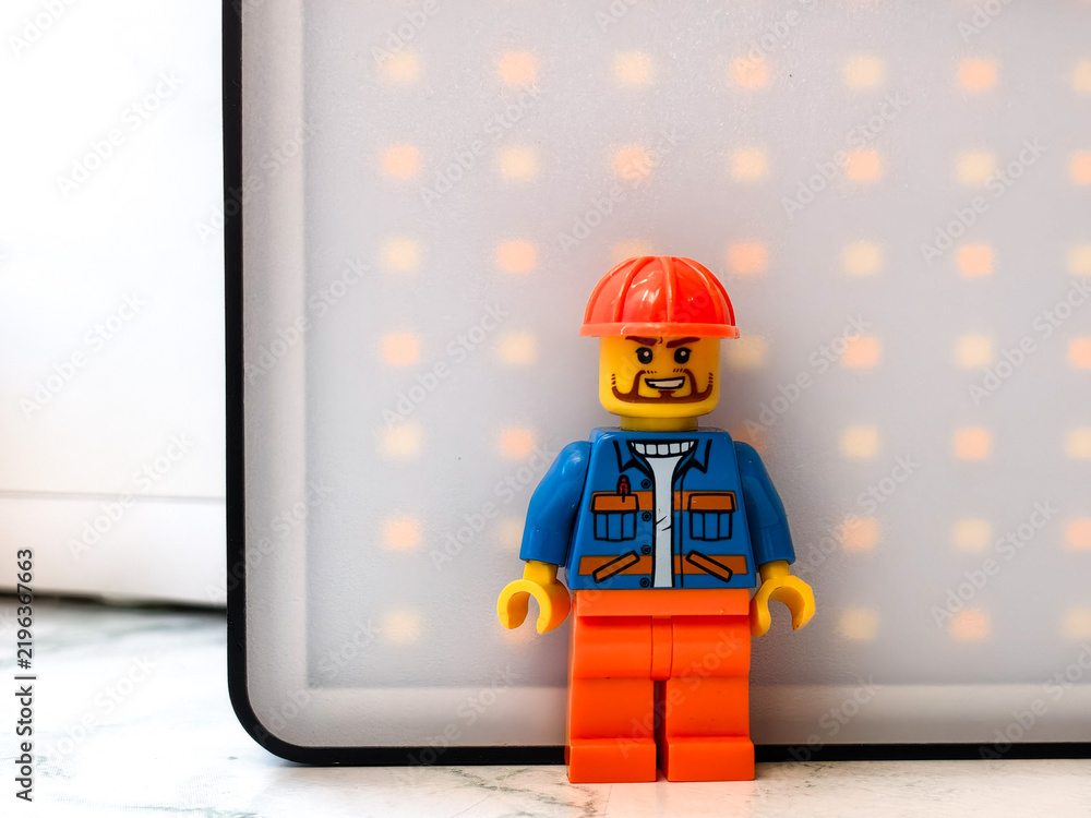 Fototapeta premium Russia, St. Petersburg, August 8, 2020. Lego man sitting in front of a LED panel, great for creative projects and illustrations.