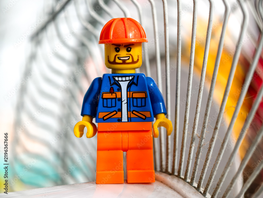 Fototapeta premium Russia, St. Petersburg, August 8, 2020 A close-up of a Lego man wearing a hard hat, perfect for illustration or design use