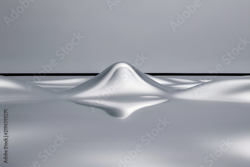 Abstract metallic landscape with a chrome ridge and mirrored surface under a soft gray sky