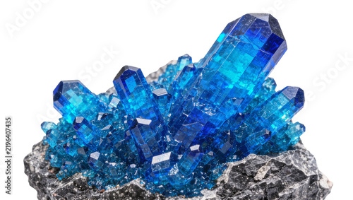 Vibrant blue crystal cluster growing from dark rock, isolated on transparent background
