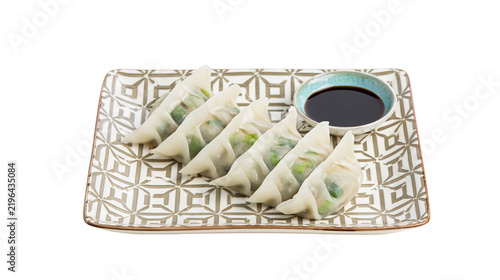 фотографія Isolated delicious Japanese gyoza dumplings with soy dipping sauce on a decorati