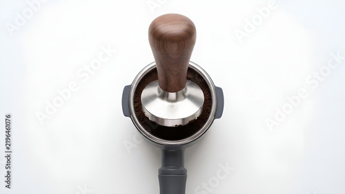 Top down view of a coffee tamper pressing grounds into a portafilter.
