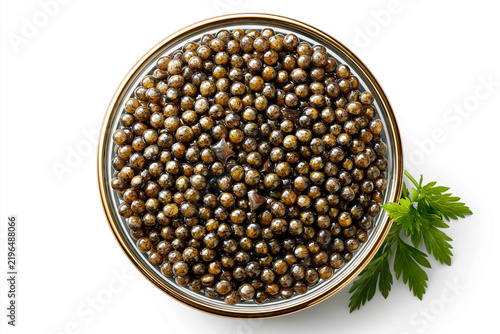 Caviar displayed in a glass jar with a sprig of parsley nearby