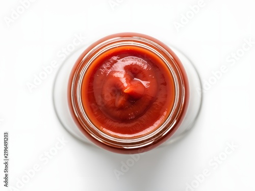 Jar of smooth tomato-based hot sauce with clean white lid for food packaging and branding