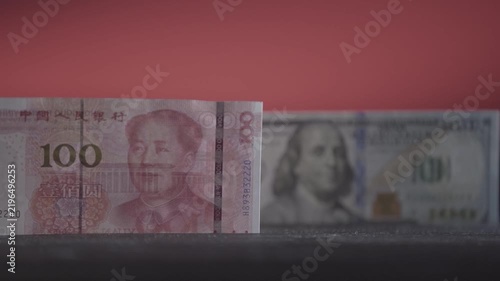 One hundred yuan and one hundred dollars; shifting the focus from one banknote to the other. The concept of the world's two competing economies.