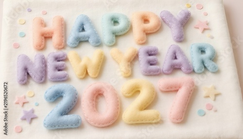 Stuffed pastel felt letters spelling happy new year 2027 on fabric
