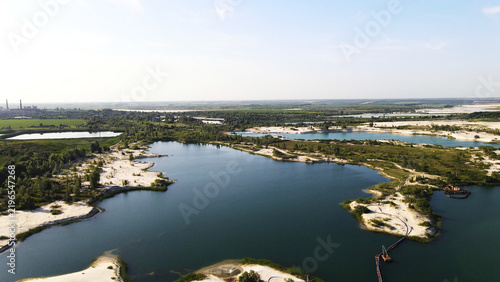 Фотография Landscape of a sand and gravel quarry operation with industrial equipment and fa