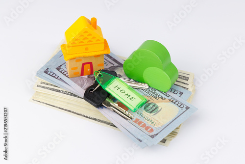 Konstfotografi Real estate rental concept featuring a yellow model house resting on US dollar c