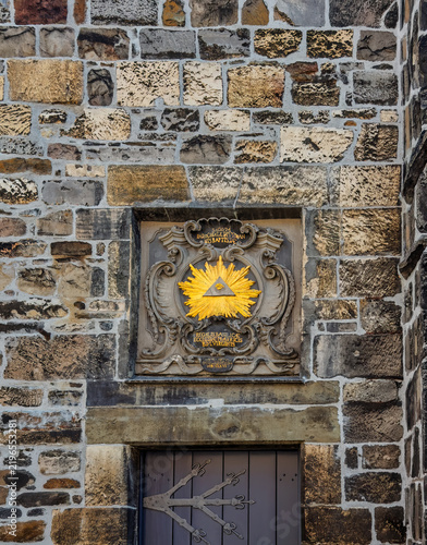 Aachen, Germany, Europe - July 28, 2026: Golden Relief on the Dom Hof: Eye of Providence or All-Seeing Eye of God. The eye within a triangle symbolizes the Holy Trinity and divine providence, surround