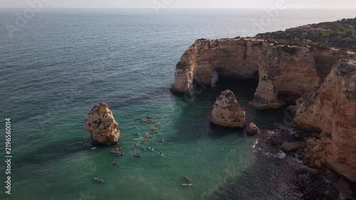 People kayaking and paddle boarding near marinha beach in algarve, portugal