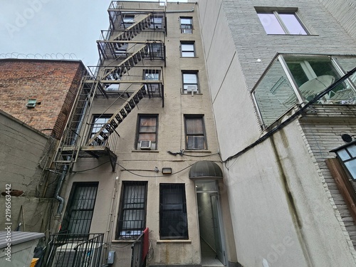 Foto Rear courtyard with fire escapes on tan brick