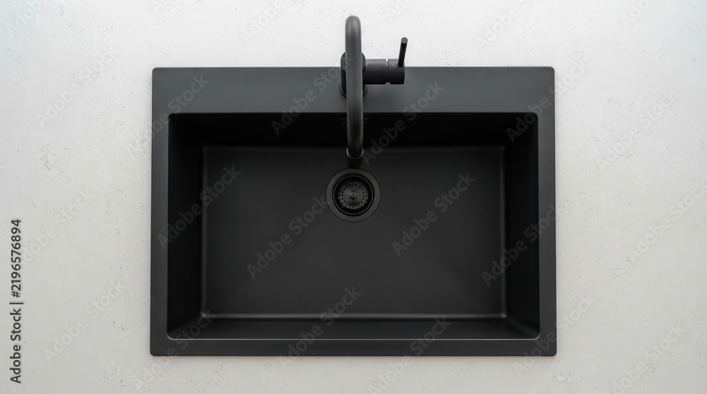 Fototapeta premium Modern matte black kitchen sink with matching faucet seen from above