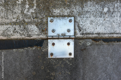 This metal hinge secures two concrete sections