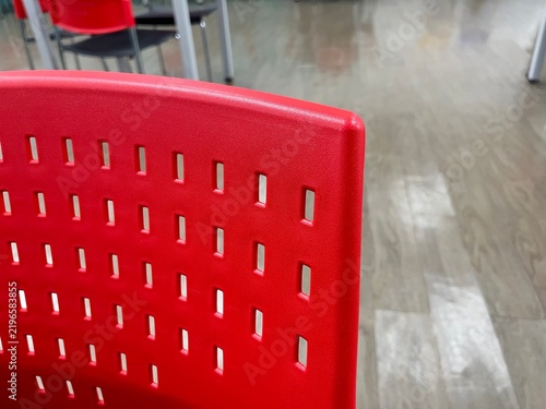 Obraz na płótnie Close up of red plastic chair backrest in office room