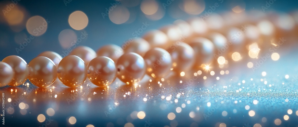 Fototapeta premium Close-up of pearl necklace resting on reflective surface with bokeh lighting in the background