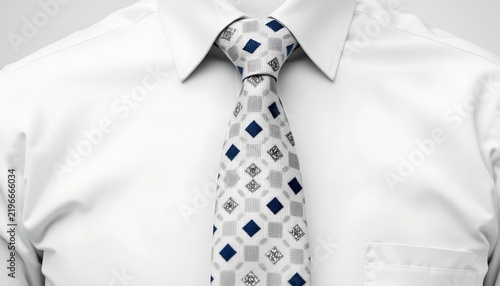 A man wearing a blue tie adorned with white polka dots and a patterned shirt, paired with a light blue dress shirt. The tie's design is the central focus of the attire.