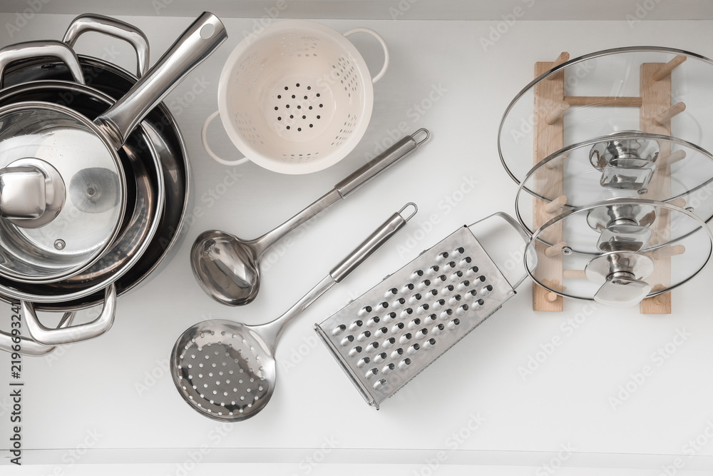 Obraz premium Kitchen organization and home cooking, stainless steel cookware and utensils arranged in a clean drawer for efficient meal preparation and storage