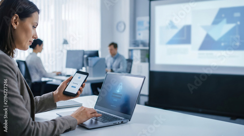 cybersecurity awareness training employee using multi factor authentication on smartphone and laptop in modern office for data protection