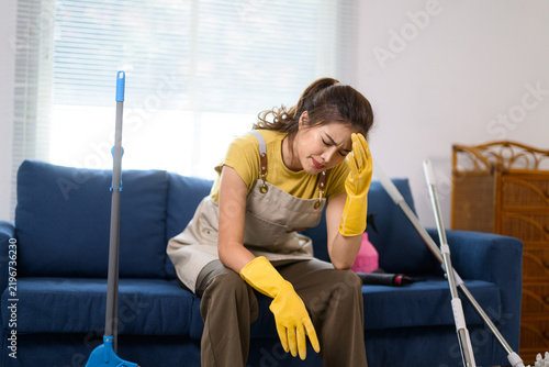 Woman feeling stressed and exhausted from household cleaning