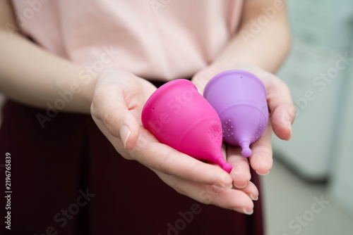 Asian woman holding menstrual cup for hygiene menstrual period cycle protection.