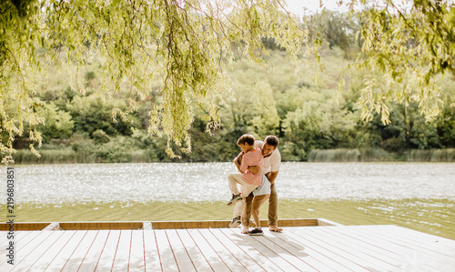 Couple enjoys a sunny day on a peaceful lakeside deck