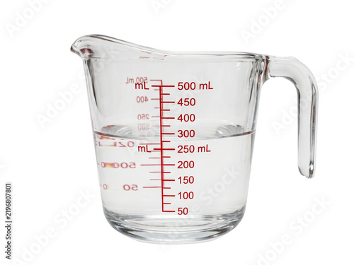Fotografie Clear glass measuring cup with metric and imperial markings for precise liquid m