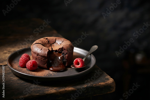 Chocolate dessert luxury ad — 9:16, 4320 × 7680
Photorealistic vertical food advertising image of a decadent chocolate lava cake with glossy molten center, raspberries and cocoa dust, deep dark studio