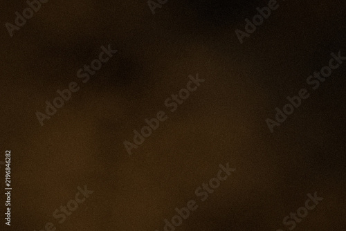 Dark grainy gold sheet texture with yellow gradient, subtle film grain, soft light, abstract backdrop and generous copy space