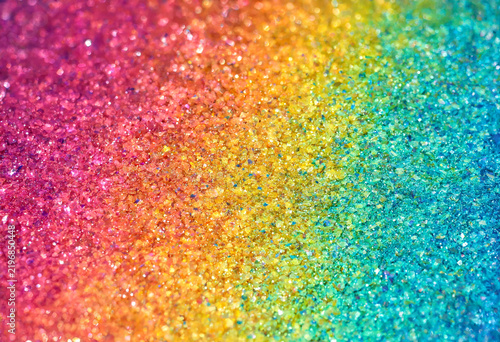 Colorful glitter particles displaying vibrant rainbow gradient texture close up
