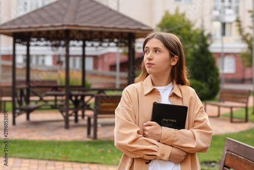 Canvastavla Faith and spirituality, young woman holding a holy bible outdoors with a thought