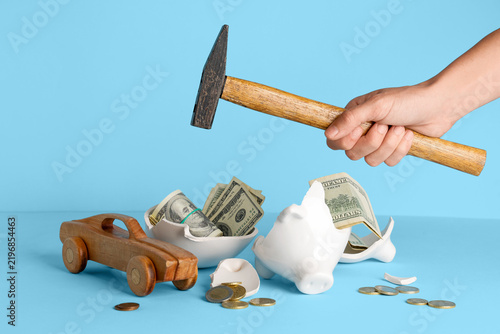 Cuadro en lienzo Financial crisis and debt, broken piggy bank with cash and wooden car toy loss o