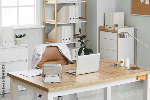 Doctors workplace with laptop and telephone in medical office