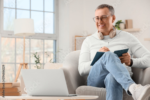 Remote work and lifelong learning, mature man attending online course on lapt...