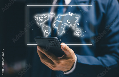 Business professional using a smartphone with a world map and phone icons, representing global communication, mobile connectivity, international calls, networking, and remote business.