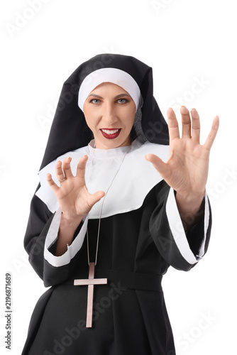 Happy mature woman dressed as nun with wooden cross isolated on white backgro...