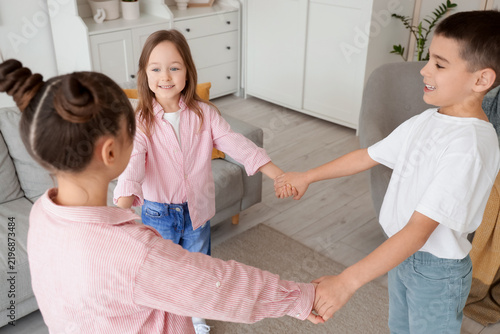 Cute little friends dancing at home