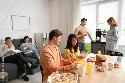 Group of business people having lunch in office kitchen