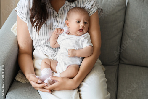 Young woman with her baby at home, closeup